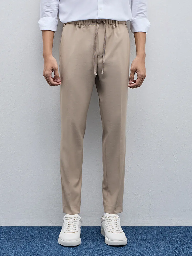 WES Formals Beige Solid Carrot-Fit Mid-Rise Trousers